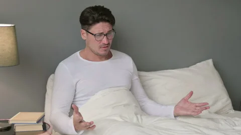 Worried Middle Aged Man in Bed Feeling Upset, Distress Stock Footage 142370993