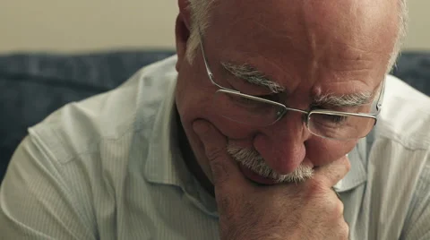 Worried old man sitting alone on the couch Stock-Footage 67535748