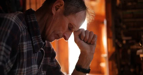 Worried old man sitting in workshop. close-up portrait of a senior man thinking Stock Footage 127943927