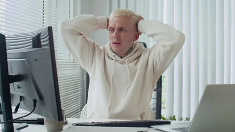 Worried Programmer Reacting to Computer Screen at Office Stock Footage 303559017