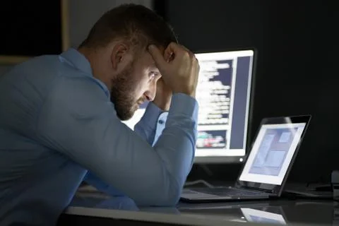 Worried Programmer Working Late At Night Stock Photos