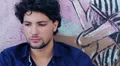 worried ,Sad, depressed young man sitting near a graffiti wall HD Footage