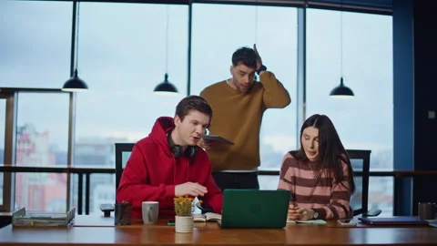 Worried staff video calling in office coworking space looking laptop webcam. Stock Footage 340076312