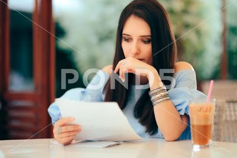 Worried Woman Reading Document Papers in a Restaurant Stock Photos