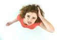 The worried woman stand on the white background. View from above Photo