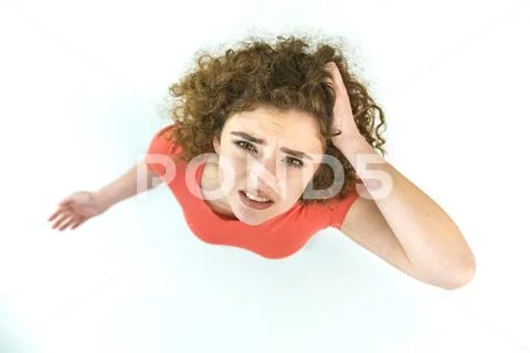 The worried woman stand on the white background. View from above Stock Photos