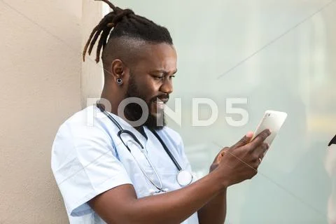 Worried Young African American Doctor With Tablet Computer