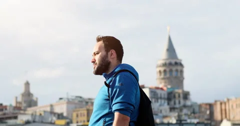 A Worried Young Man While Smoking Cigarette in front of Galata Tower Видео 162021728