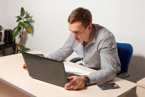 Worry businessman using laptop while sitting in office. pensive office worker Stock Photos