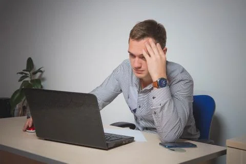 Worry businessman using laptop while sitting in office. pensive office worker Foto stock