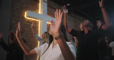 Worshippers raising hands in devotion, group of diverse people with focus on man Stock-Footage 302130241