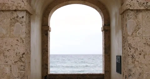 Worth Avenue Clock Tower view through arches Atlantic Ocean Waves crashing Stock Footage 213138687