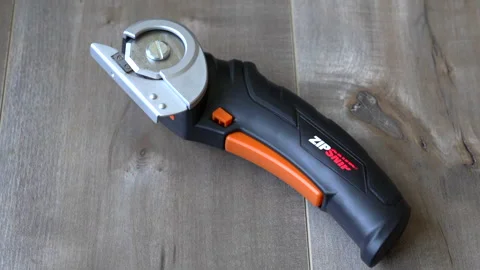 Worx Zip Snip Electric Scissors on Wooden Floor Stock Footage 325761546
