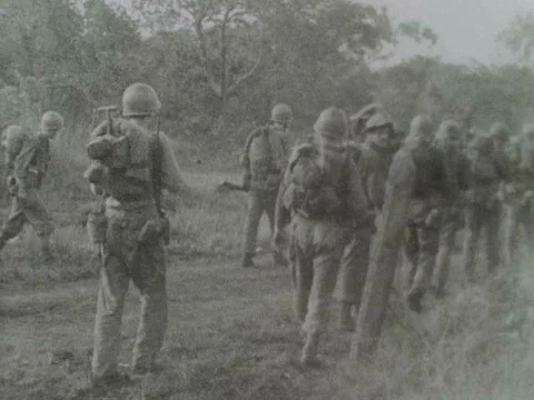 Wounded and sick U.S. Army soldiers, tiredly hike through the mountainousƒ Stock Footage 75298775