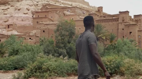 Wounded black guy looks around at the sand house of Morocco 02 Video stock 67557514