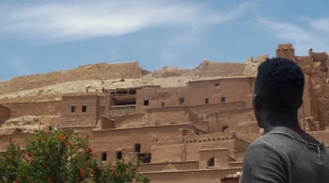 Wounded black guy looks around at the sand house of Morocco 05 Video stock 67557549