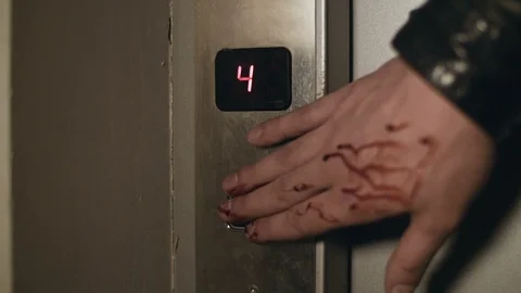 Wounded bleeding hand is pushing elevator button Stock Footage 114715803