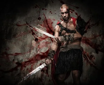 Wounded gladiator with two swords covered in blood Stock Photos