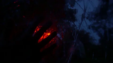 Wounded hand from which blood flows that slips on the car windshield cracked Stock Footage 146309681