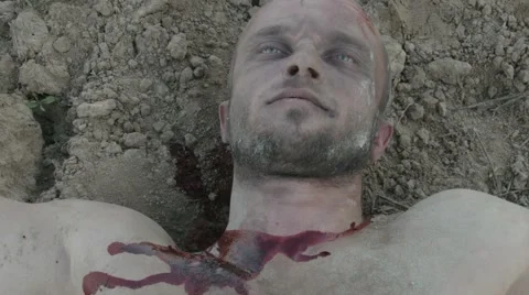 The wounded man being dragged along the ground. Video stock 68609778