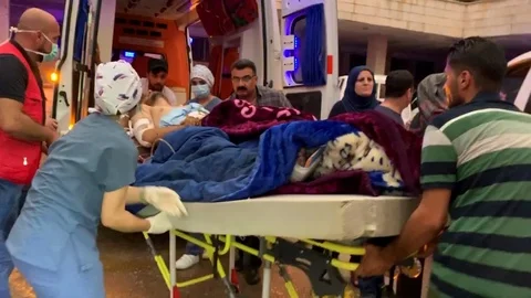 A Wounded Man Being Loaded into an Ambulance co Stock Footage 120941338