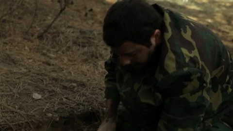 A wounded soldier digs in the ground 7 Video stock 323021709