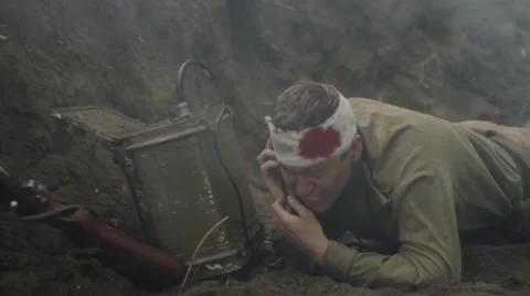 Wounded Soviet soldier during combat action crawls to portable radio. Stock Footage 65957570