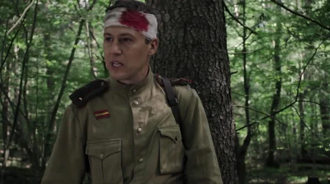 Wounded Soviet soldier emotionally speaks standing in the woods. World War II. Video stock 65956681