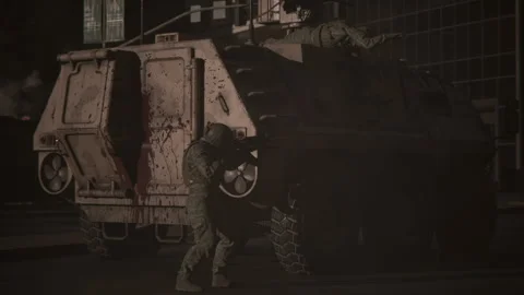 A wounded tank soldier asks for help, while the other opens fire in battle Stock Footage 289191409