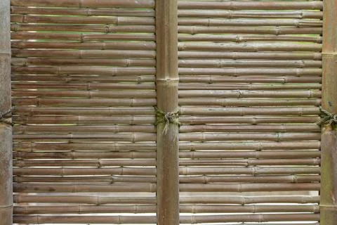 Woven bamboo fence panel texture with vertical posts Stock Photos