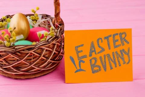 Woven basket filled with Easter eggs. Stock Illustration
