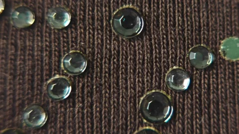 Woven brown textile background with rhinestones, changing light, cloth shaking Stock Footage 280669091