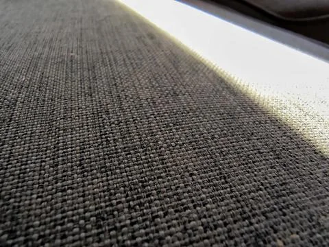 Woven fabric texture with dramatic diagonal light and shadow Stock Photos