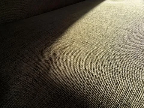 Woven fabric texture with dramatic diagonal light and shadow Stock Photos