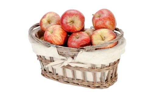 Woven lined wicker basket filled with red apples Stock Photos