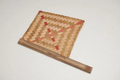 Woven mat with geometric pattern and red accents Stock Photos