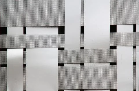 Woven metal pattern on black background Stock Photos