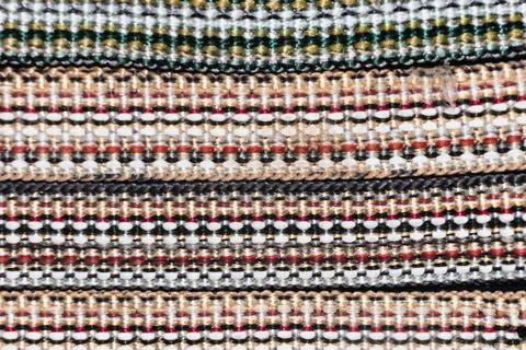 Woven multi-colored threads create a colorful, bright image of the braid Stock Photos