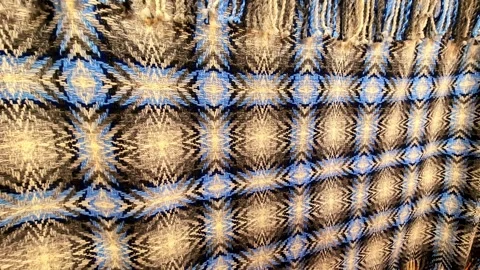 Woven textile with a mesmerizing geometric pattern in close up for abstract 스톡 동영상 348066021