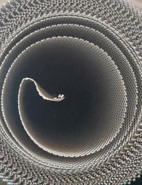 Woven Wire Mesh Roll Creating Spiral Industrial Pattern Stock Photos