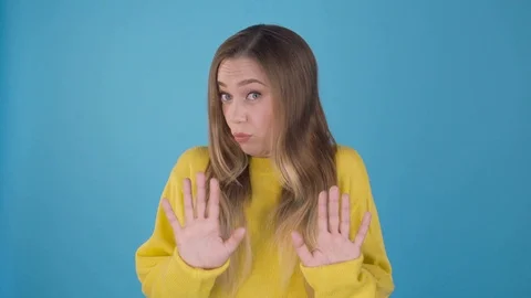 Wow wow take it easy. A lead attractive girl on a blue background shows a Stock Footage 109269842