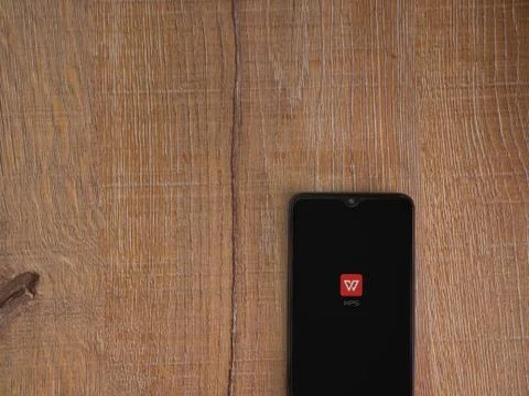 WPS Office app launch screen with logo on the display of a black mobile smart Stock Photos