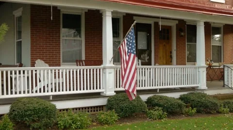 Wrap around porch with flag  Stock Footage