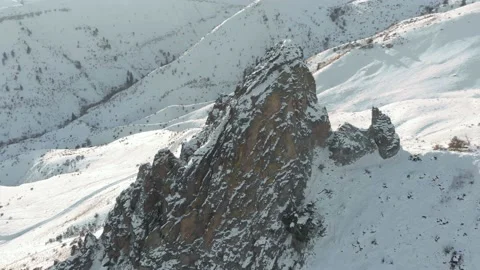 Wrap around shot of rock tower in the snow, 4K Stock Footage 168911658