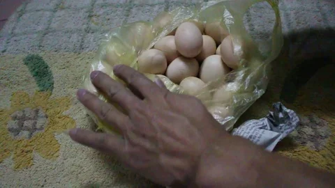 Wrap eggs into paper Stock Footage 78170765