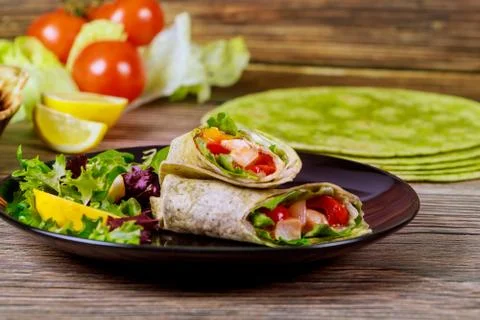 Wrap with meat and vegetable made from spinach tortillas. Stock Photos