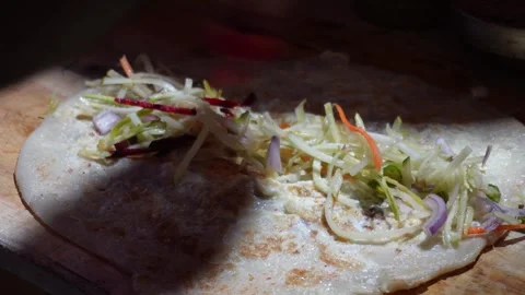 A wrap or egg roll being prepared 스톡 동영상 326332032