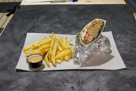 A wrap with a side of fries Stock Photos