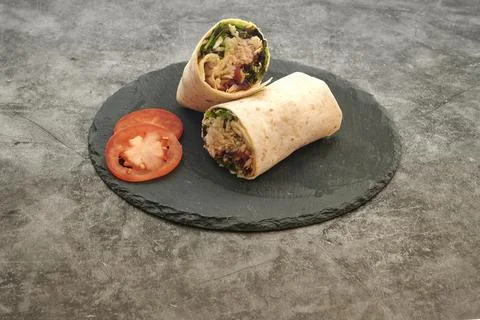 A wrap with a tomato on top of it Stock Photos