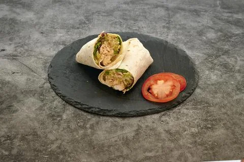 A wrap with a tomato on top of it Stock Photos